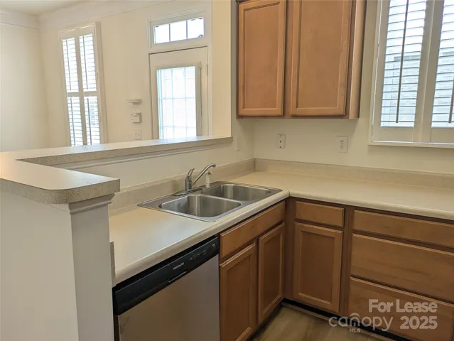 a kitchen with a sink cabinets and window