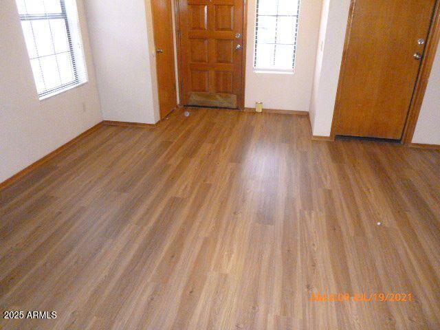 1915 North Ave De Palmas Casa Grande, AZ 85122 - Photo 15 of 24 an empty room with wooden floor and windows