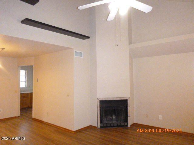 1915 North Ave De Palmas Casa Grande, AZ 85122 - Photo 17 of 24 a view of an empty room with wooden floor and a fireplace