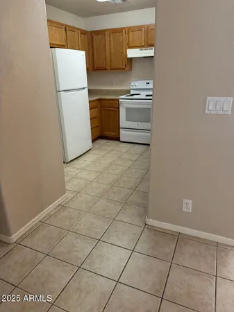 a kitchen with a stove a refrigerator and a cabinets