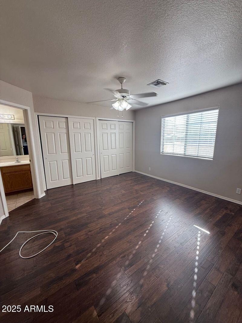 1915 North Ave De Palmas Casa Grande, AZ 85122 - Photo 9 of 24 wooden floor in an empty room with a window