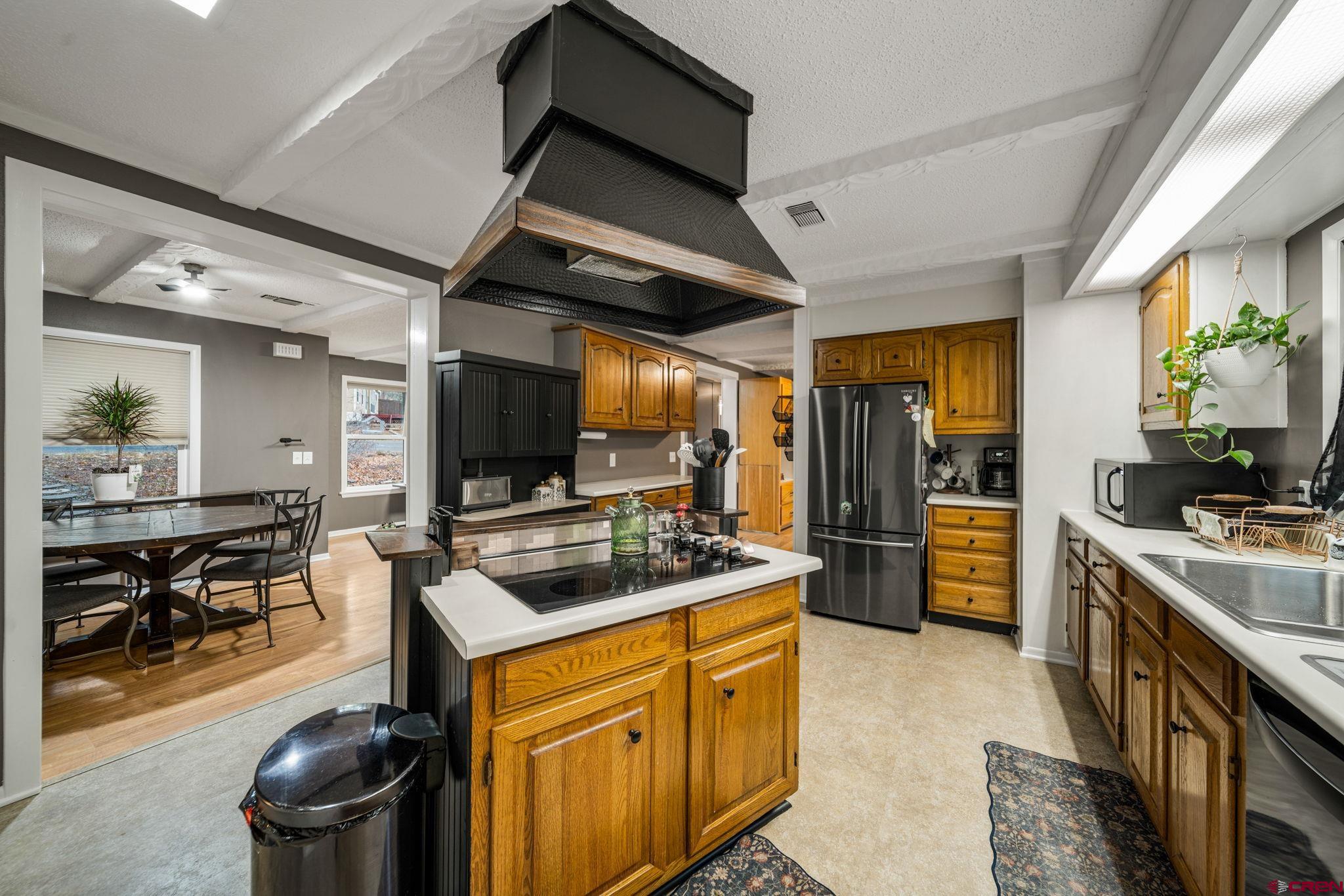 199 Timber Drive Durango, CO 81303 - Photo 11 of 29 a kitchen with stainless steel appliances granite countertop a stove refrigerator and a sink