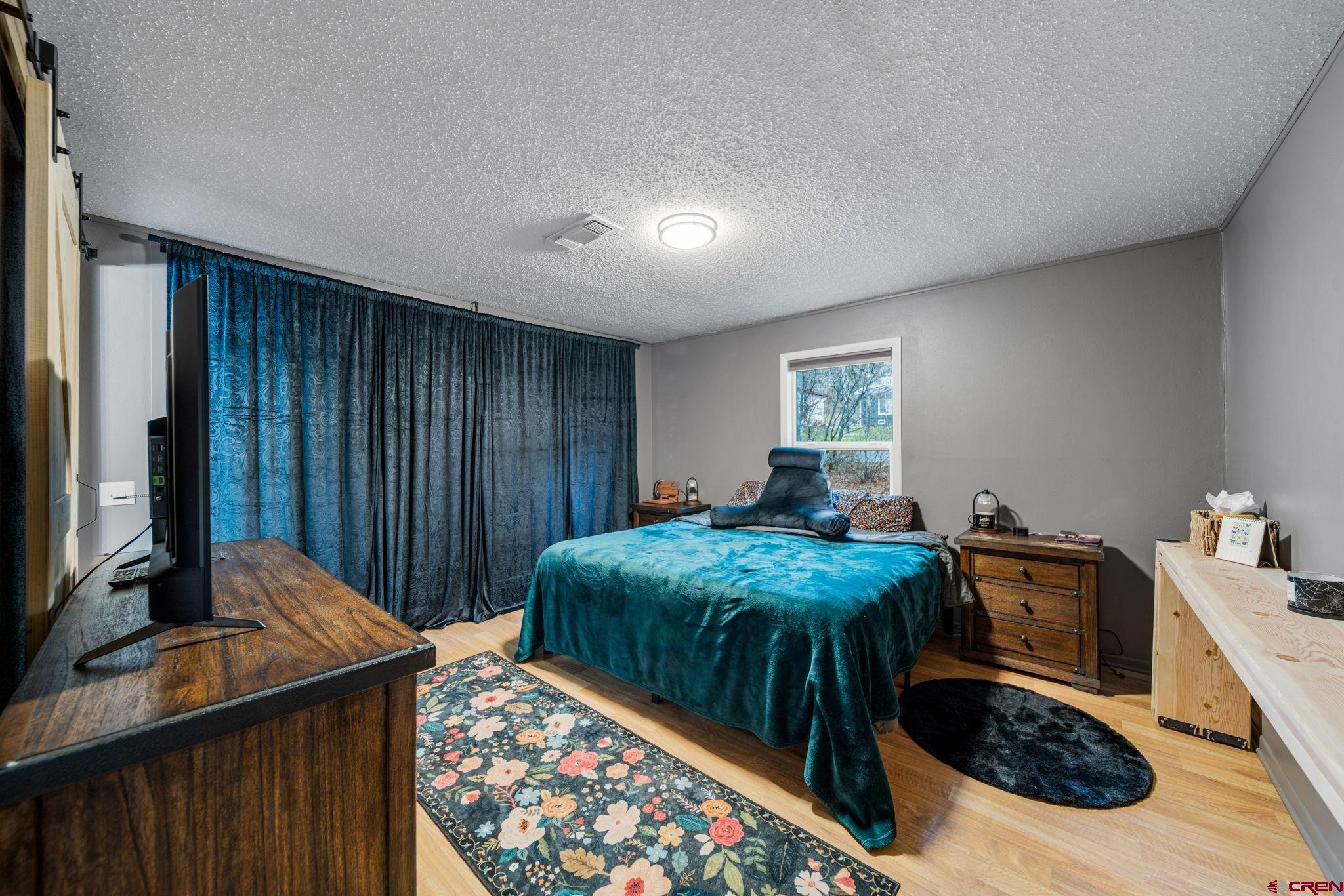 199 Timber Drive Durango, CO 81303 - Photo 13 of 29 a bed room with a bed and a television