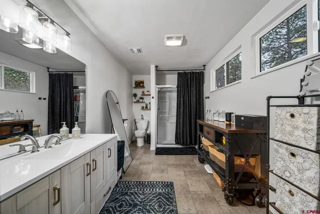 a bathroom with double vanity and mirrors