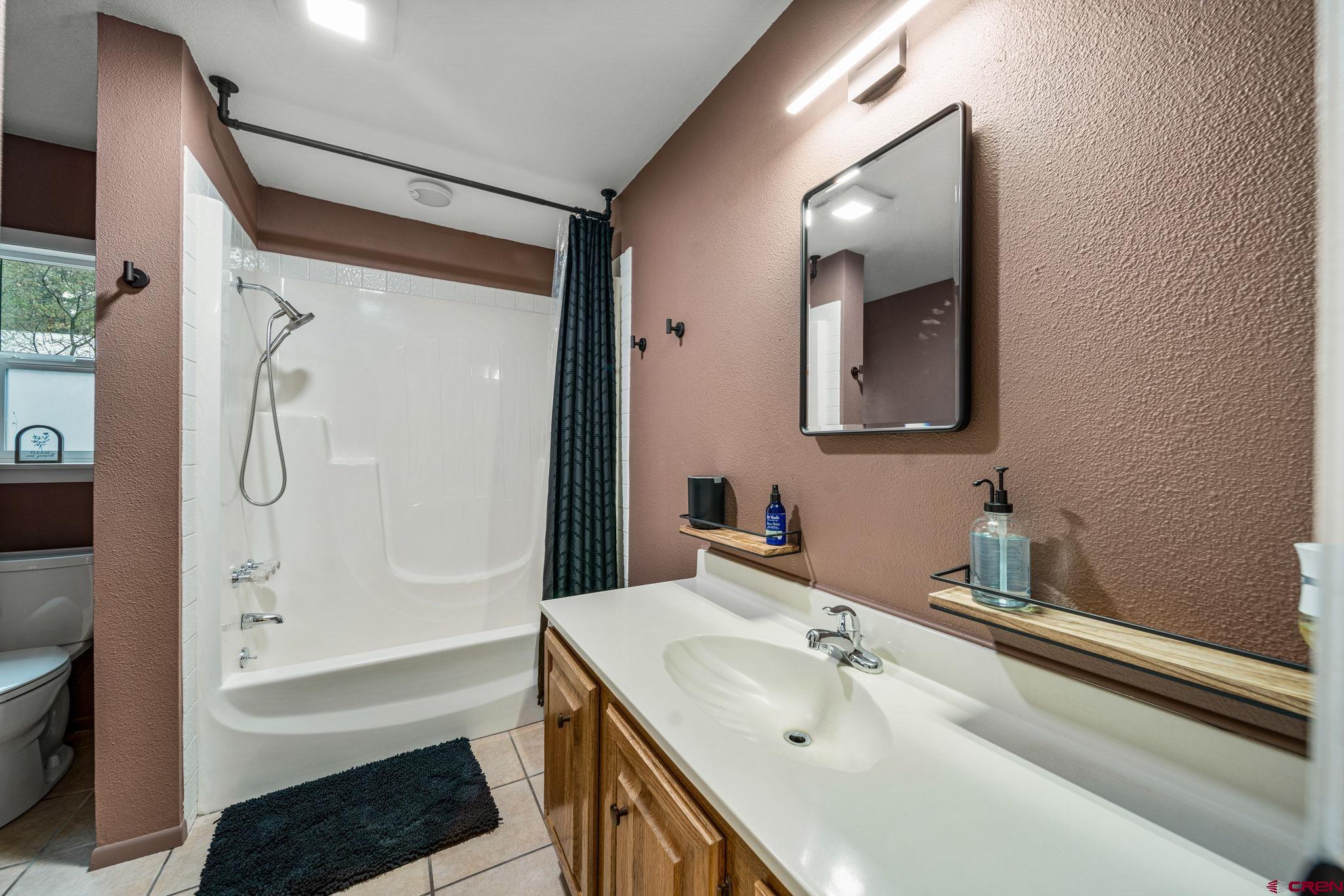 199 Timber Drive Durango, CO 81303 - Photo 20 of 29 a bathroom with a sink a toilet and bathtub