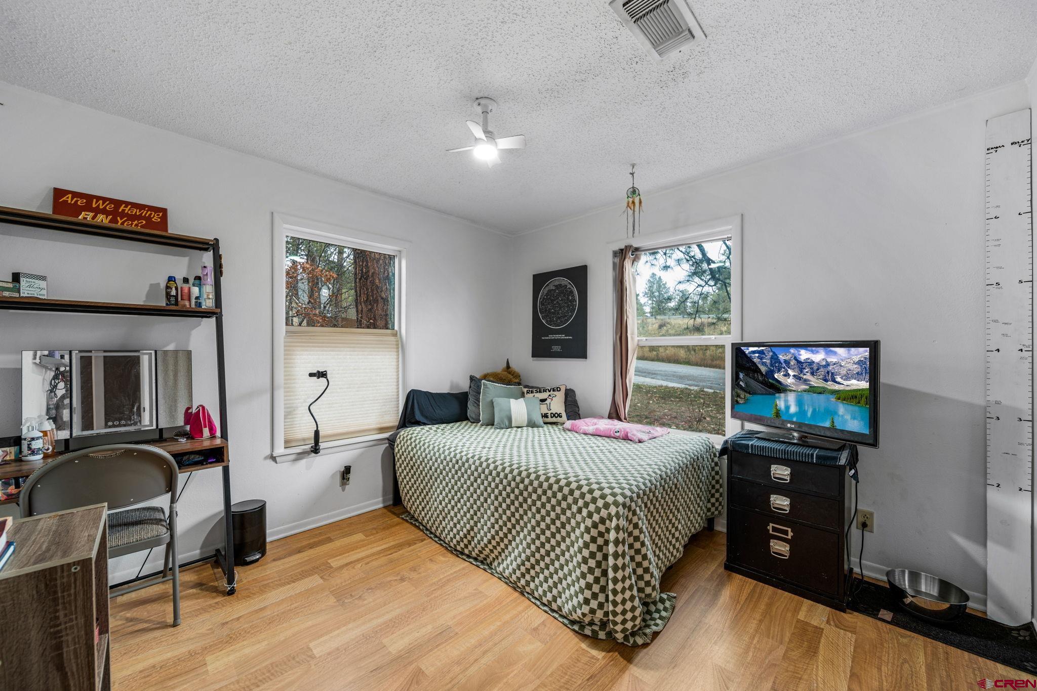 199 Timber Drive Durango, CO 81303 - Photo 21 of 29 a bedroom with a bed and wooden floor