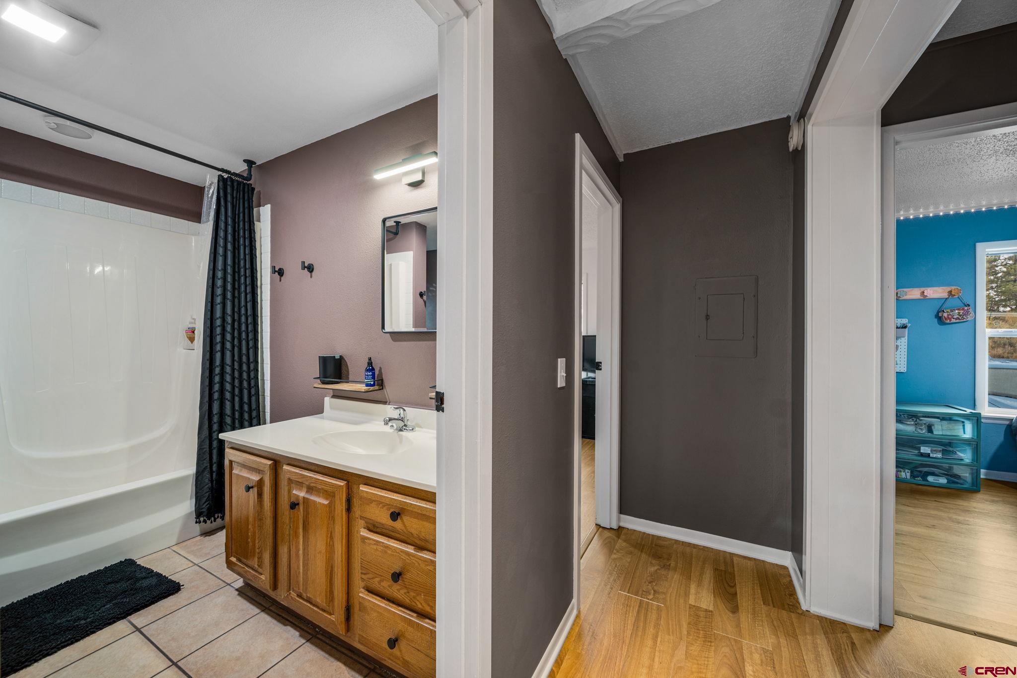 199 Timber Drive Durango, CO 81303 - Photo 23 of 29 a bathroom with a tub sink and mirror
