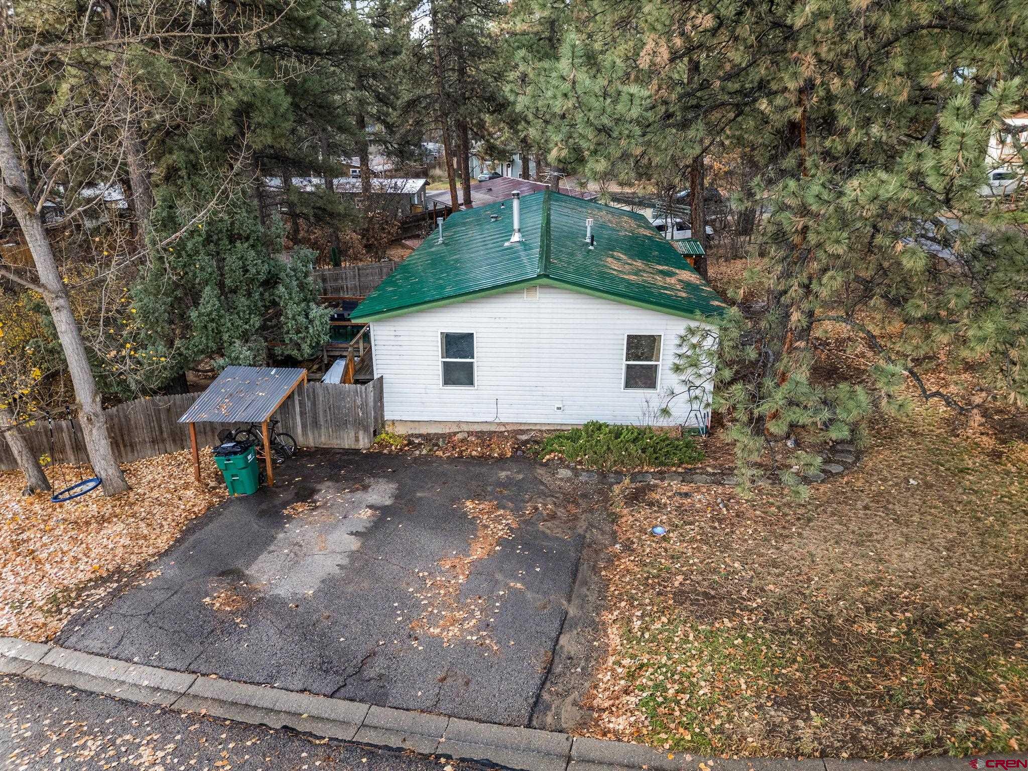 199 Timber Drive Durango, CO 81303 - Photo 29 of 29 a view of a small yard in front of a house with a large tree
