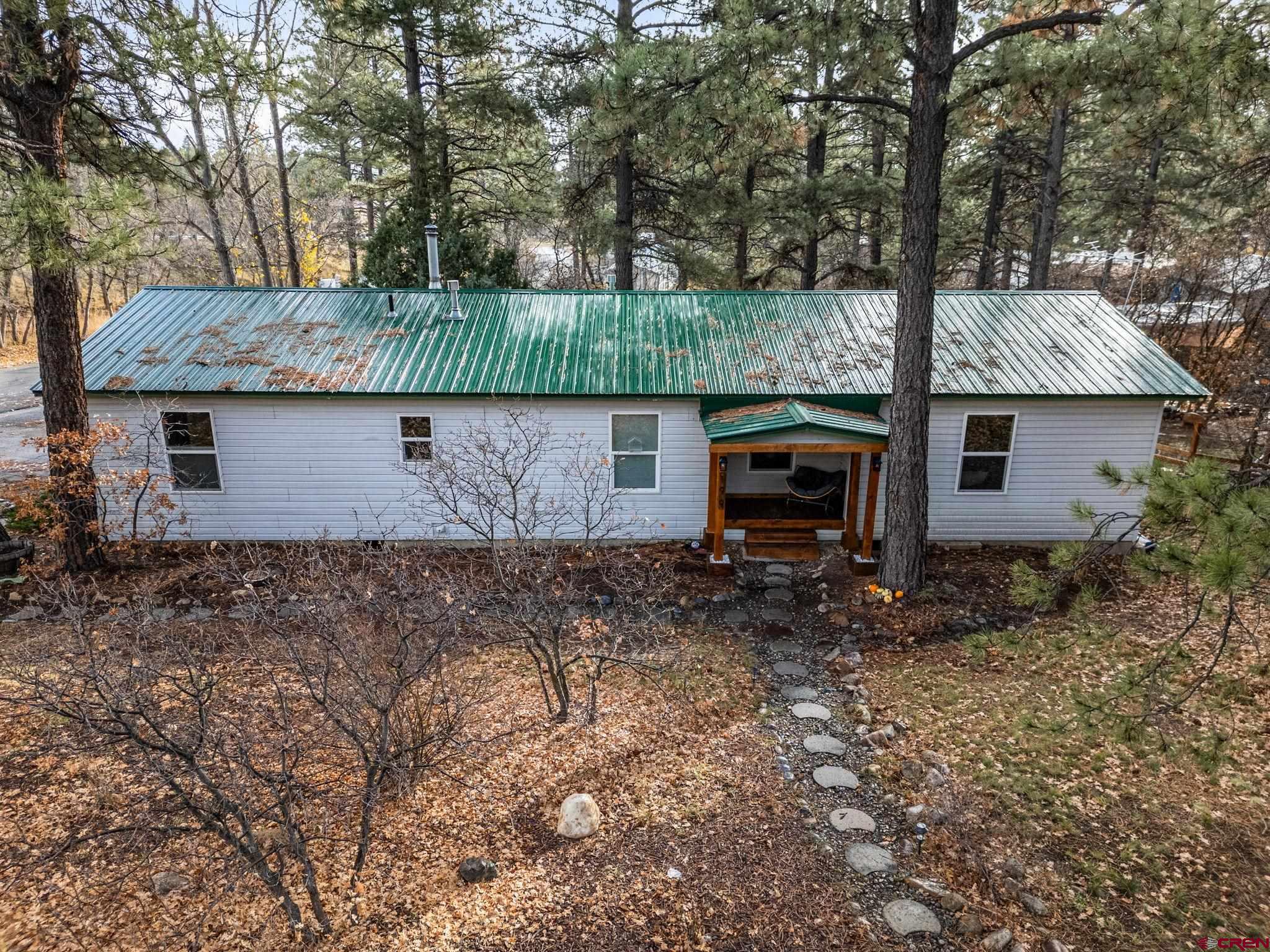 199 Timber Drive Durango, CO 81303 - Photo 3 of 29 a front view of a house with garden