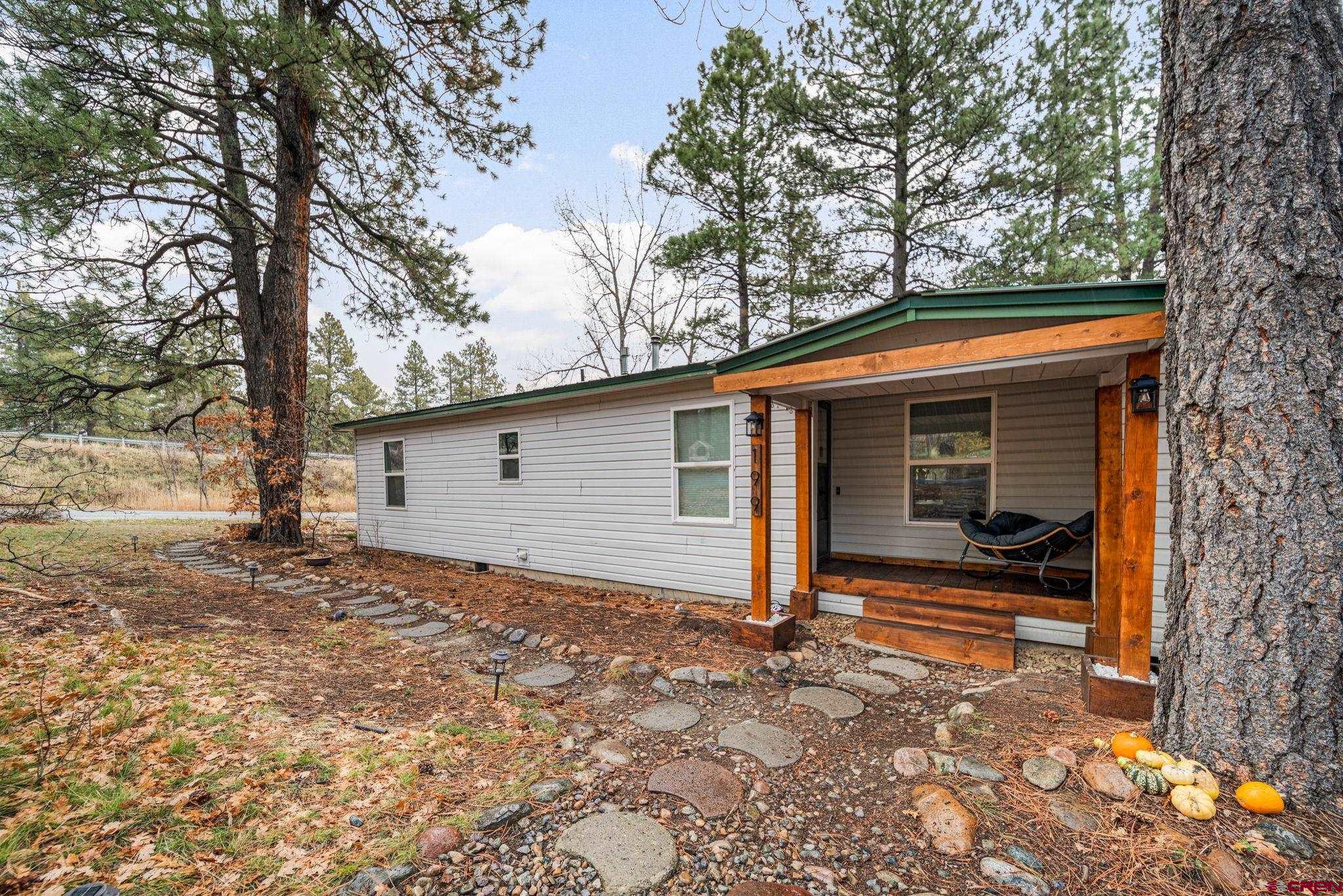 199 Timber Drive Durango, CO 81303 - Photo 4 of 29 a backyard of a house with yard and outdoor seating
