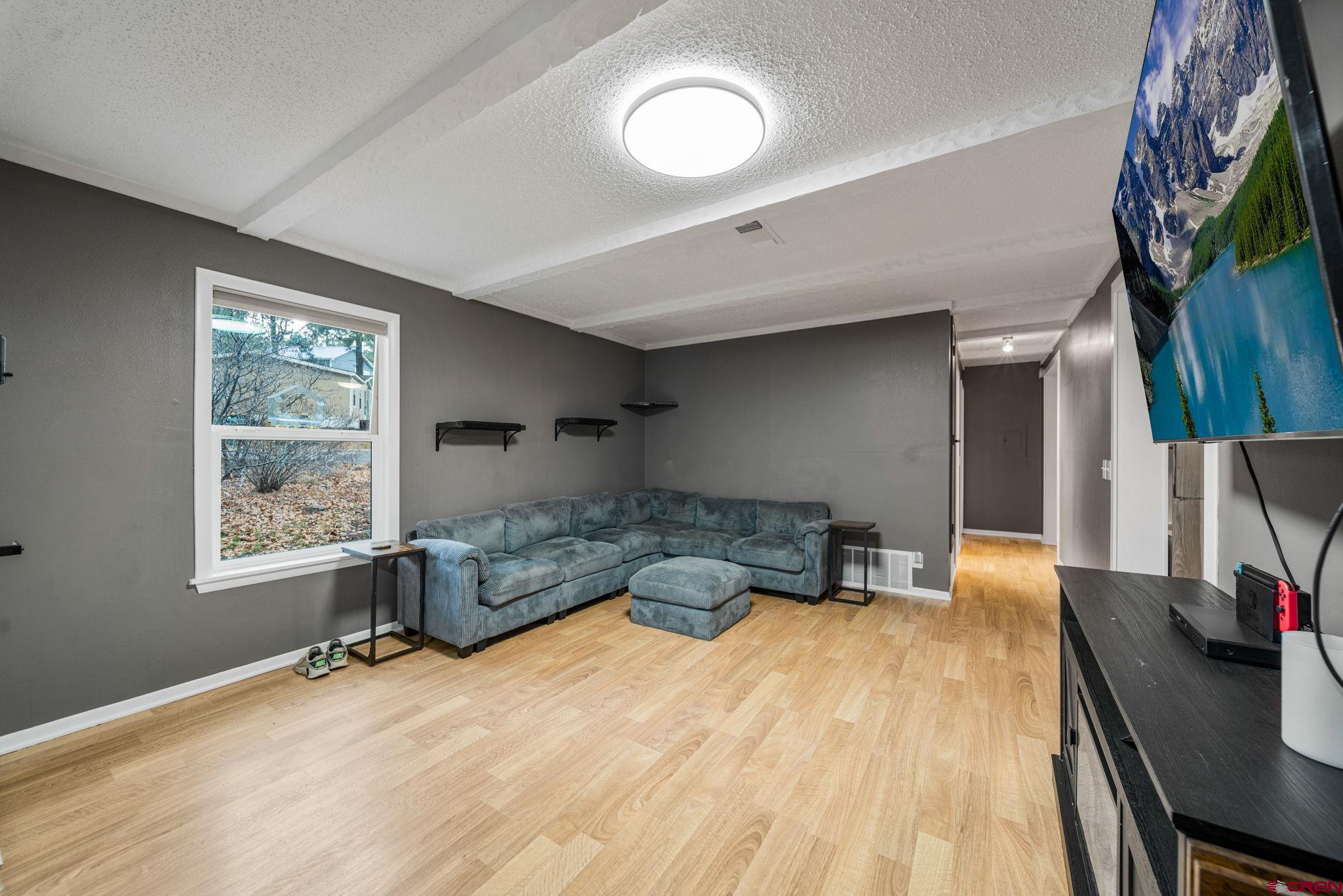 199 Timber Drive Durango, CO 81303 - Photo 7 of 29 a bedroom with a bed and a chandelier