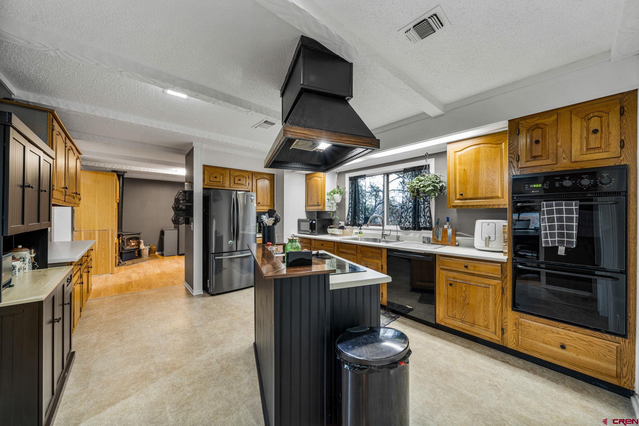 199 Timber Drive Durango, CO 81303 - Photo 9 of 29 a kitchen with stainless steel appliances granite countertop a sink and a refrigerator
