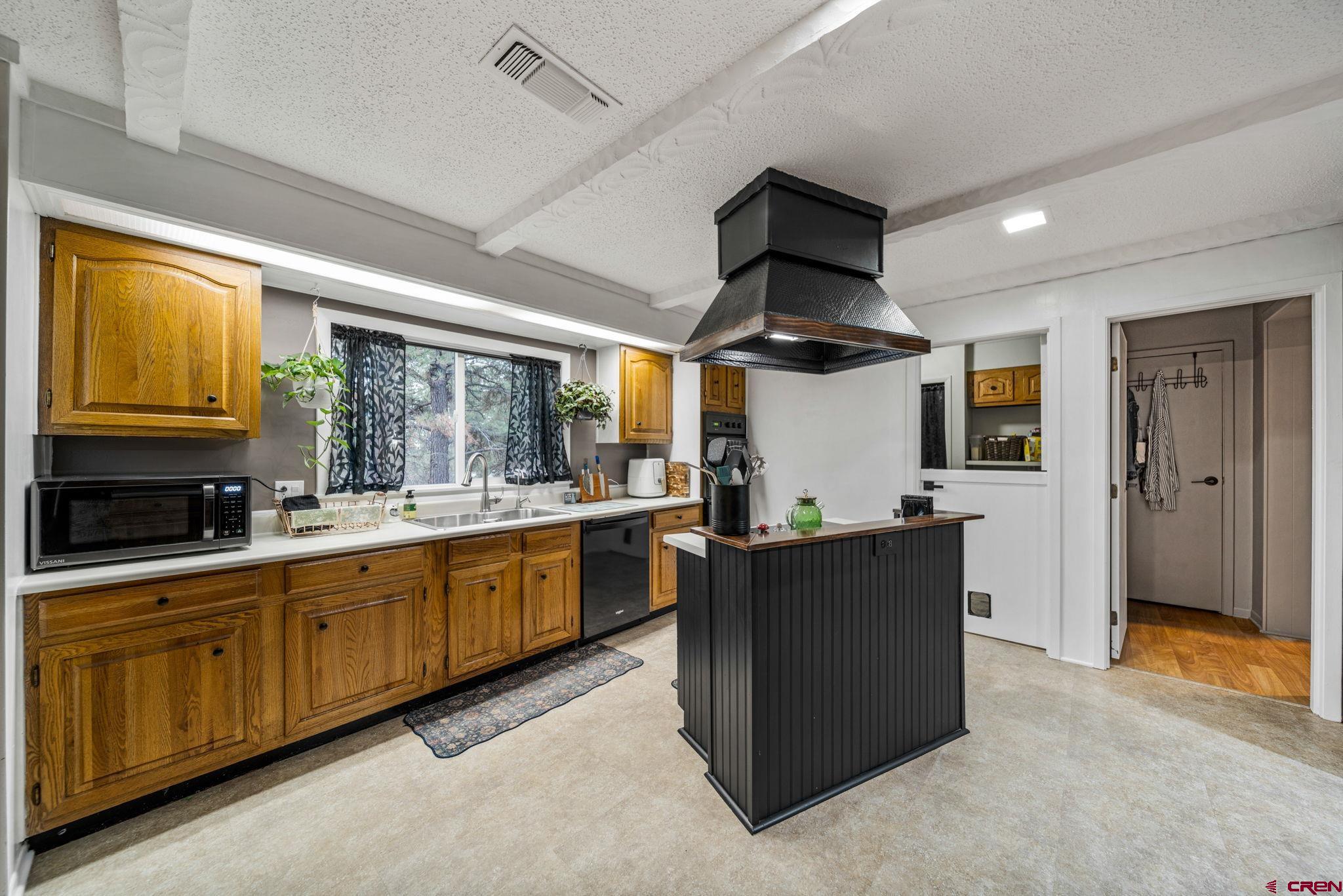 199 Timber Drive Durango, CO 81303 - Photo 10 of 29 a kitchen with stainless steel appliances granite countertop sink stove and refrigerator