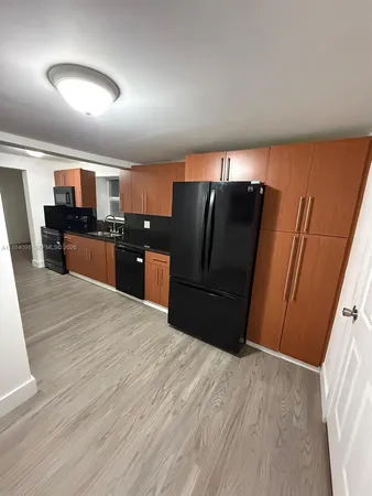 a kitchen with granite countertop a stove a sink and a microwave