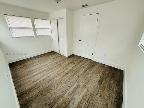 a view of closet area with wooden floor