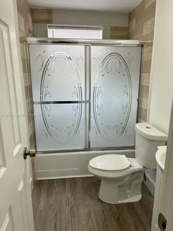 a white toilet sitting next to a bathroom sink