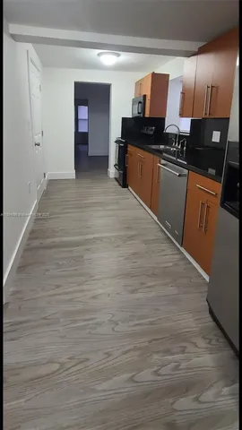 a kitchen with stainless steel appliances granite countertop a sink and cabinets