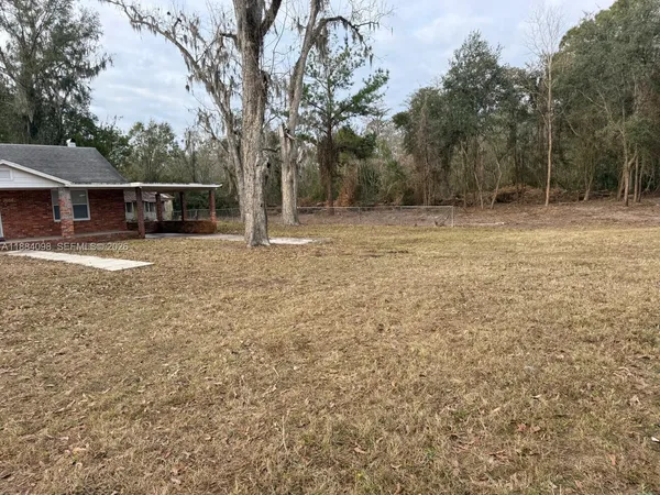 a backyard of a house with large trees