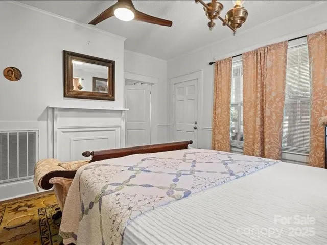 a bedroom with a bed and a chandelier