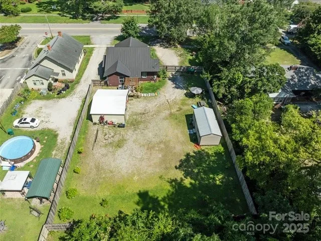 an aerial view of a house with swimming pool and outdoor space