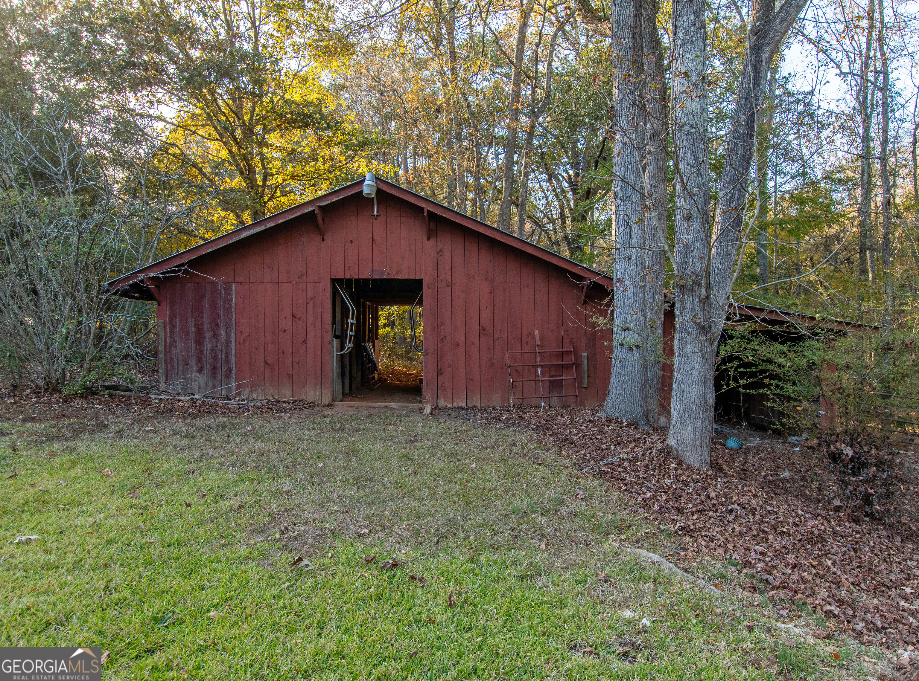 13819 Woolsey Road Hampton, GA 30228 - Photo 12 of 100 a house is sitting in middle of the forest