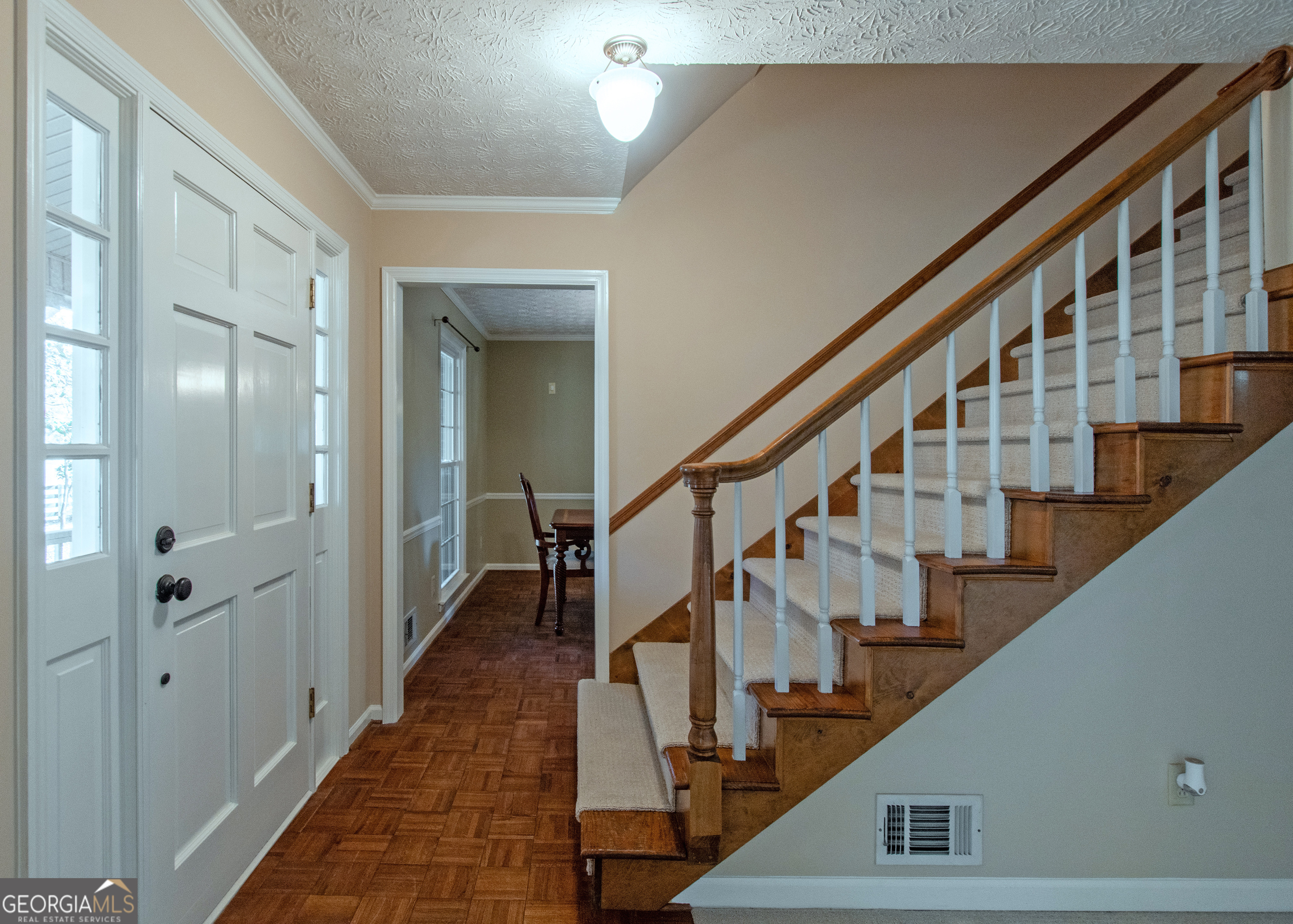 13819 Woolsey Road Hampton, GA 30228 - Photo 58 of 100 a view of staircase with lots of frames on wall and windows