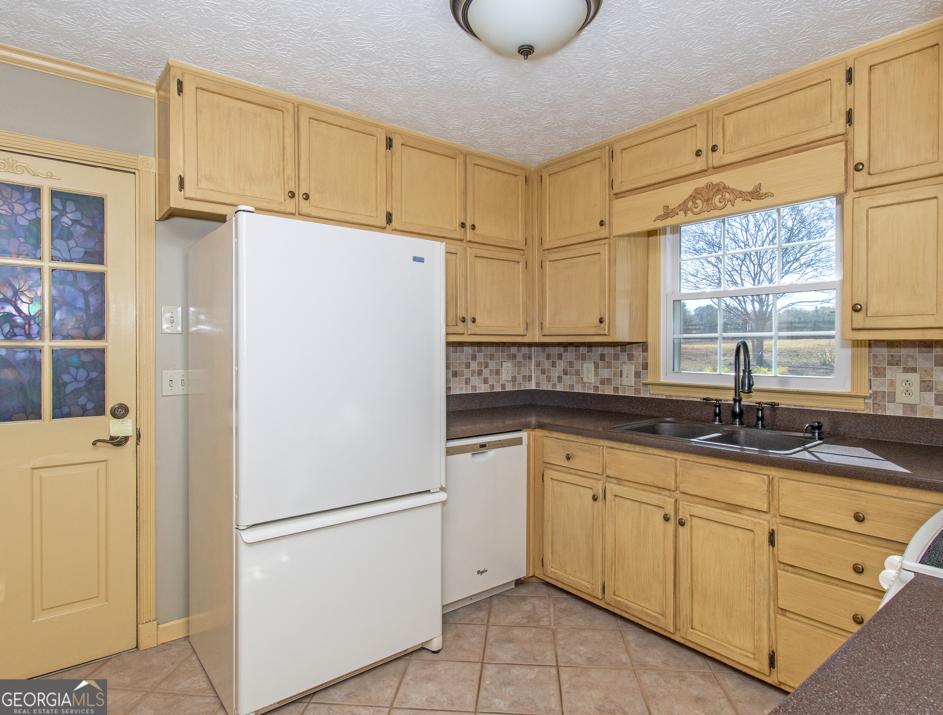 13819 Woolsey Road Hampton, GA 30228 - Photo 61 of 100 a white refrigerator freezer sitting inside of a kitchen