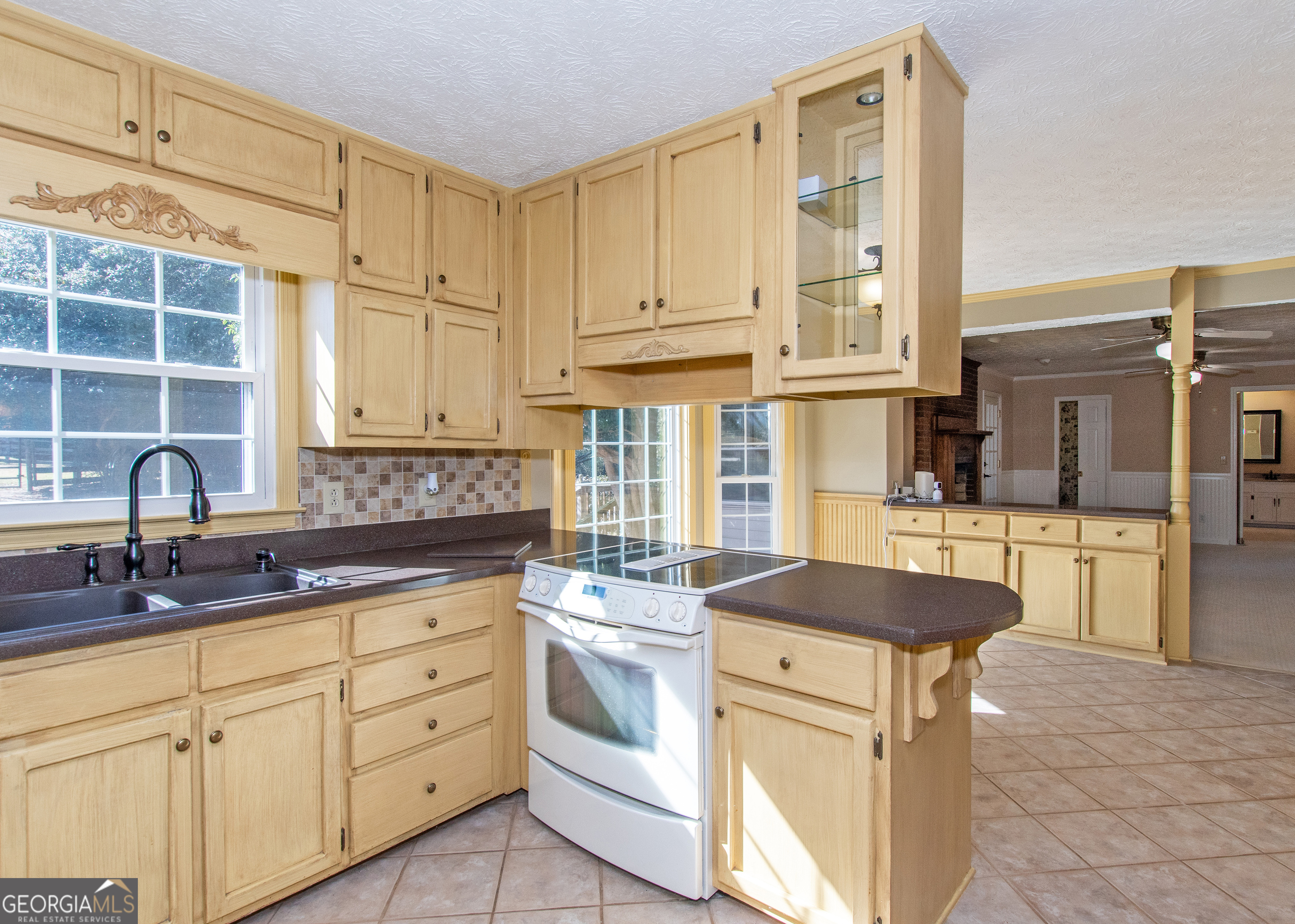 13819 Woolsey Road Hampton, GA 30228 - Photo 64 of 100 a kitchen with cabinets appliances a sink and a counter top space
