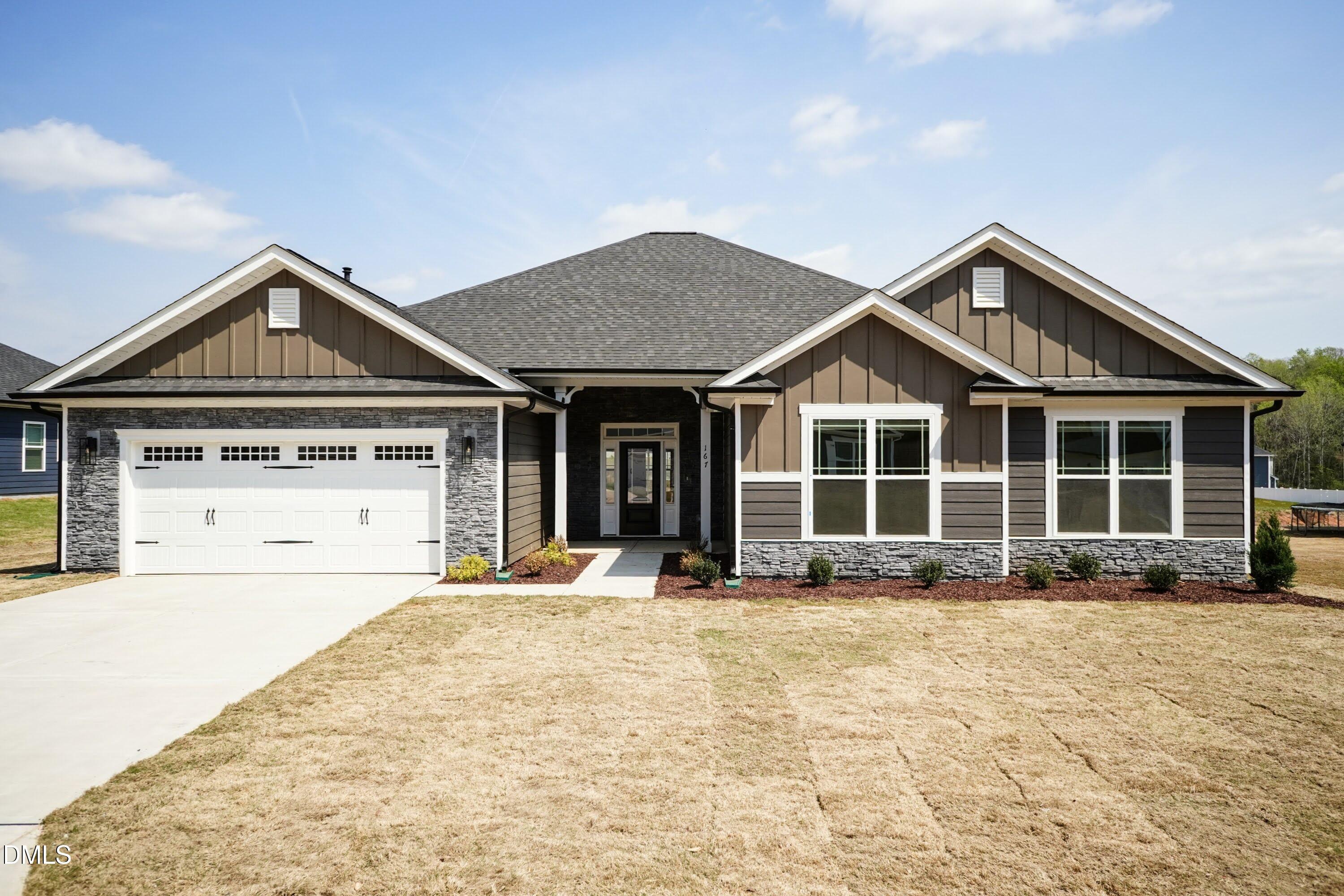 180 Galway Road Lillington, NC 27546 - Photo 1 of 41 a front view of a house with a garden and yard