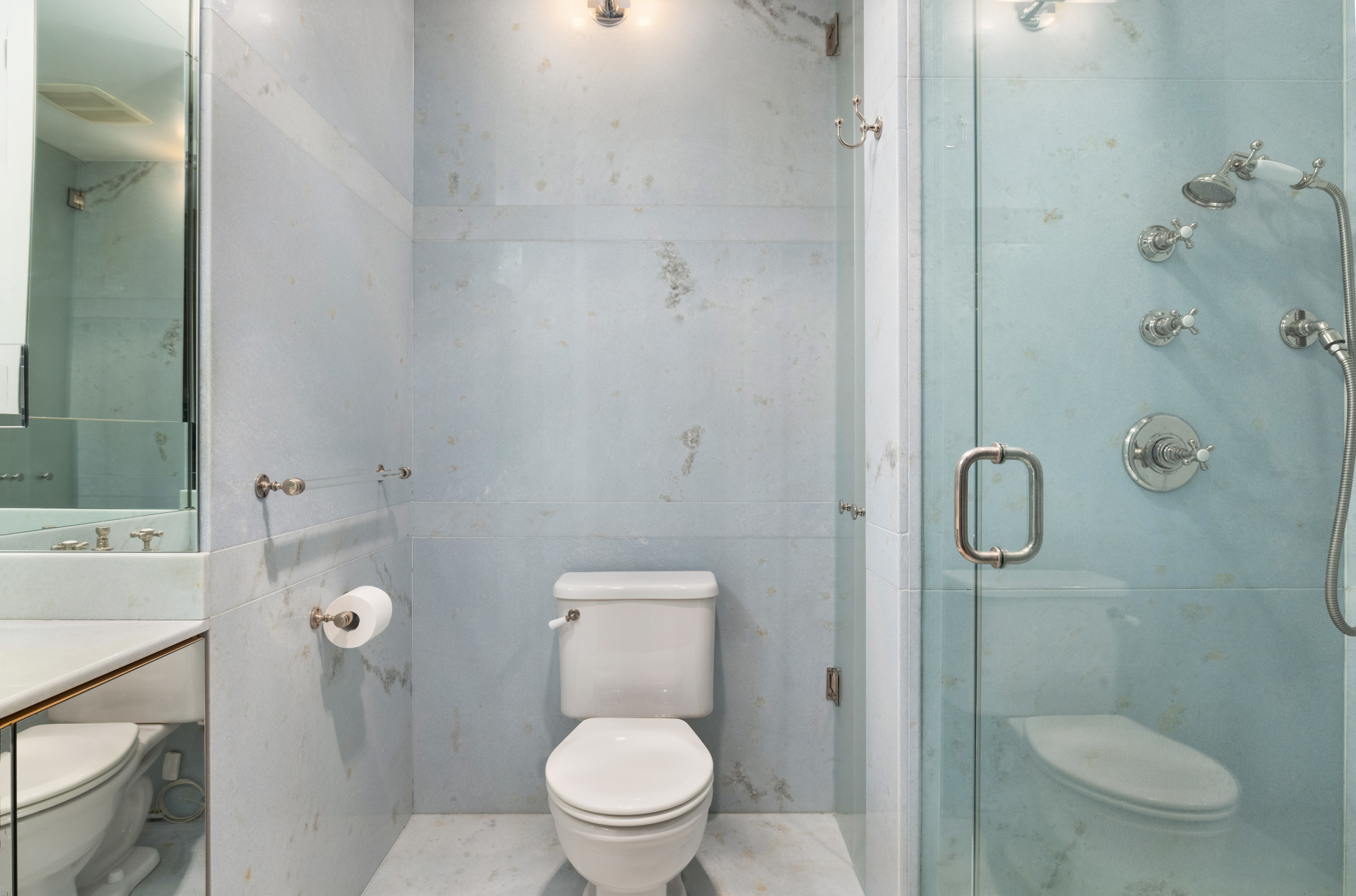 188 East 70th Street, Unit 11D Manhattan, NY 10021 - Photo 12 of 14 a white toilet sitting next to a bathroom sink