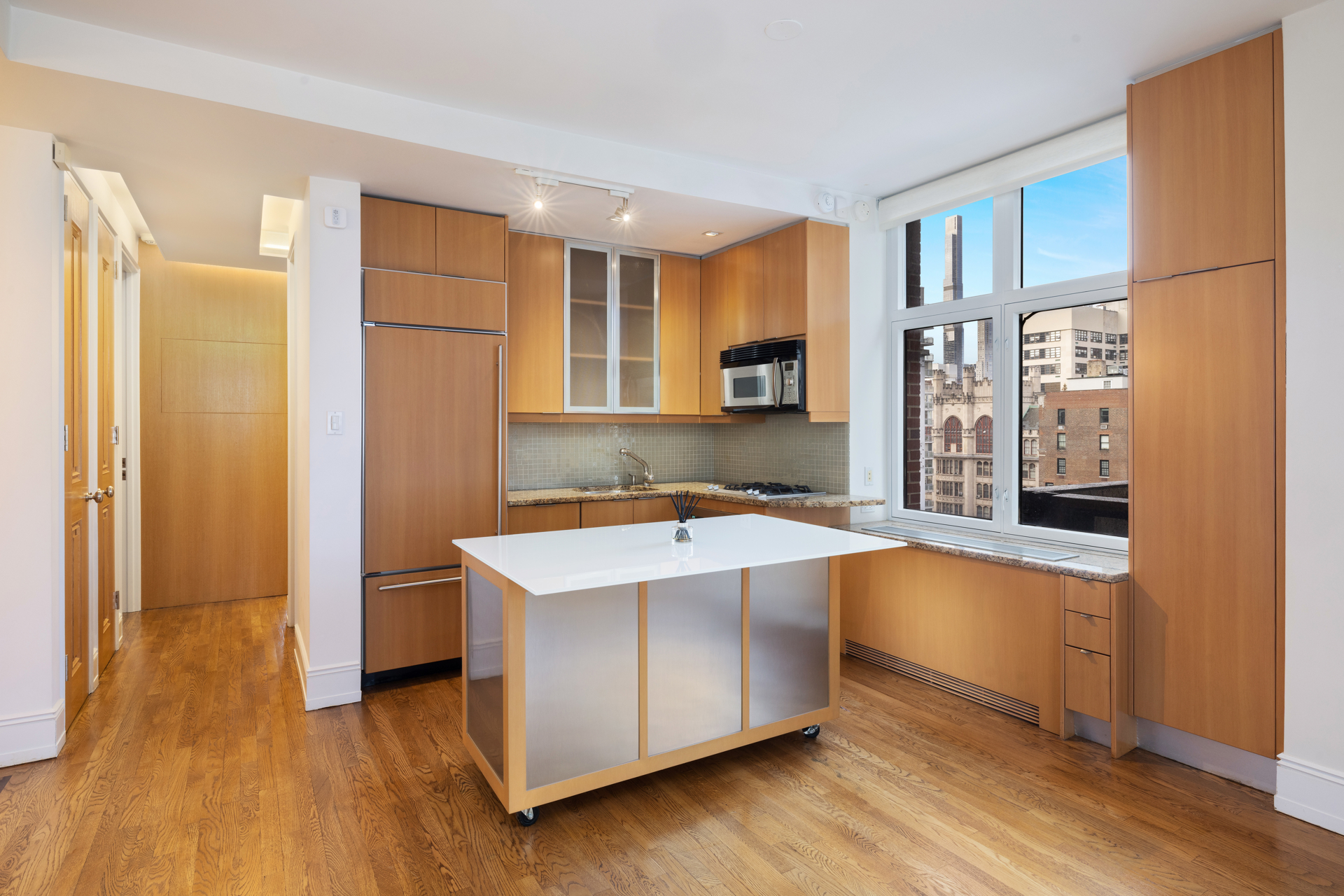 188 East 70th Street, Unit 11D Manhattan, NY 10021 - Photo 5 of 14 a kitchen with stainless steel appliances granite countertop a sink a stove and a refrigerator