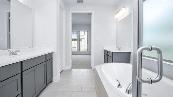 a bathroom with a tub sink and mirror