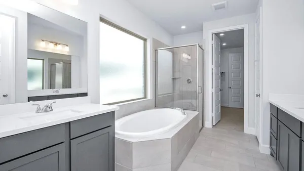 a bathroom with a bathtub shower sink and mirror