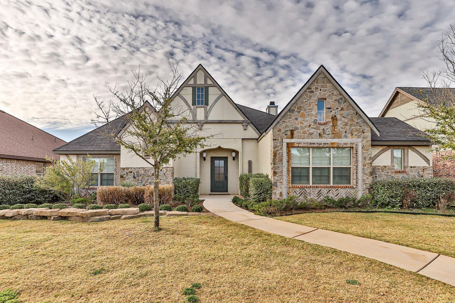 3633 133rd Street Lubbock, TX 79423 - Photo 1 of 46 a front view of house with yard and trees around