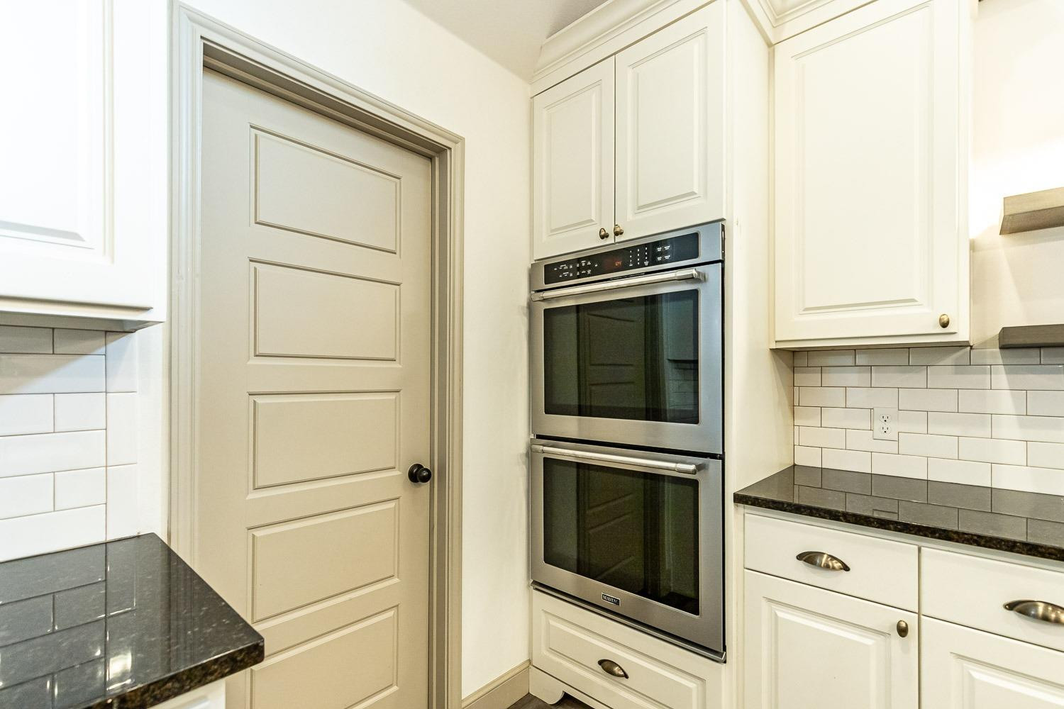 3633 133rd Street Lubbock, TX 79423 - Photo 15 of 46 a kitchen with white cabinets and white appliances