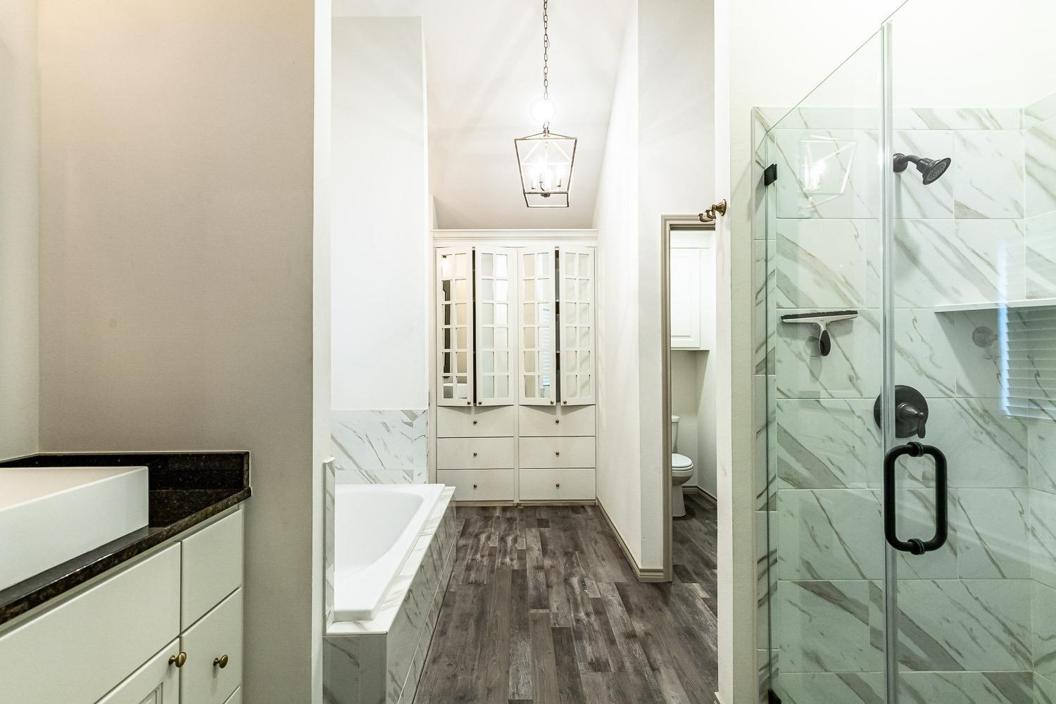 3633 133rd Street Lubbock, TX 79423 - Photo 22 of 46 a bathroom with a shower