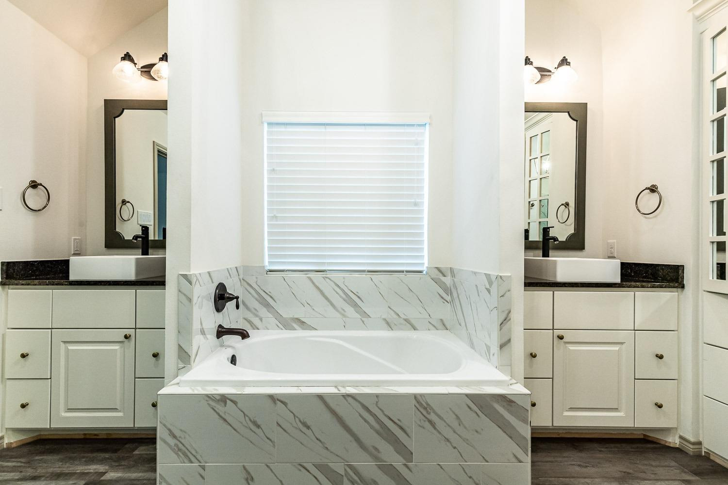 3633 133rd Street Lubbock, TX 79423 - Photo 24 of 46 a spacious bathroom with sink and mirror