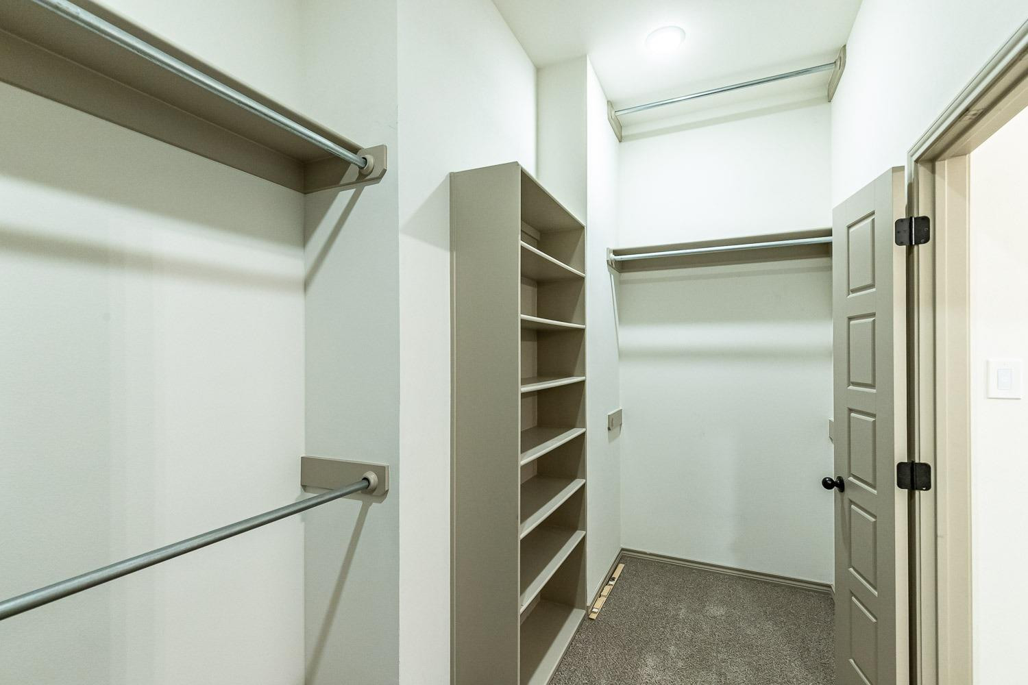 3633 133rd Street Lubbock, TX 79423 - Photo 26 of 46 a view of walk in closet with empty racks