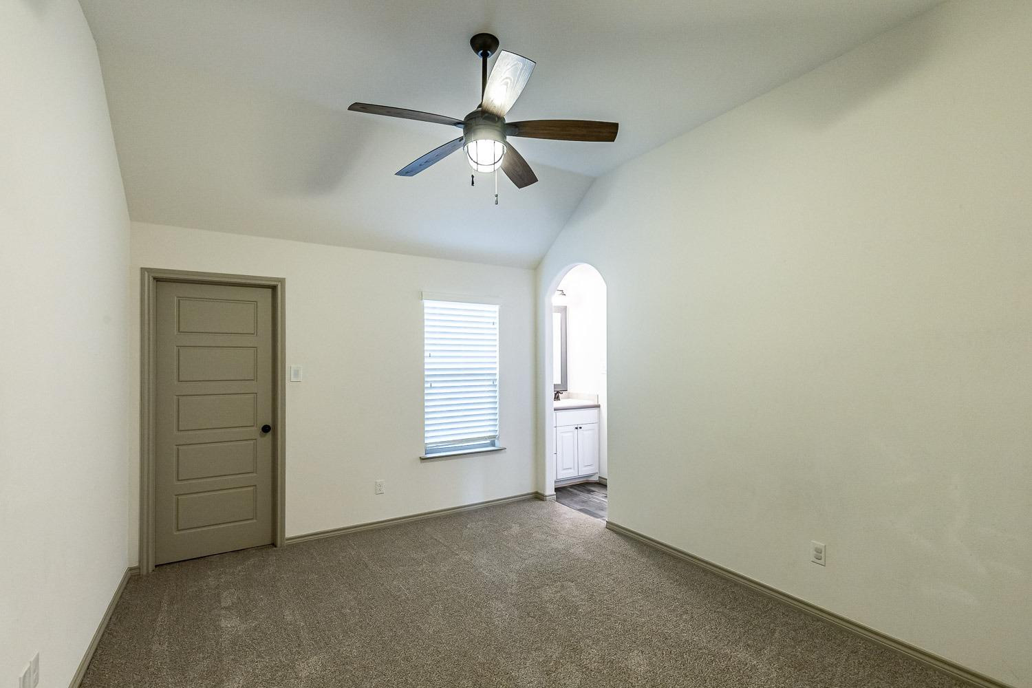 3633 133rd Street Lubbock, TX 79423 - Photo 27 of 46 an empty room with windows and fan