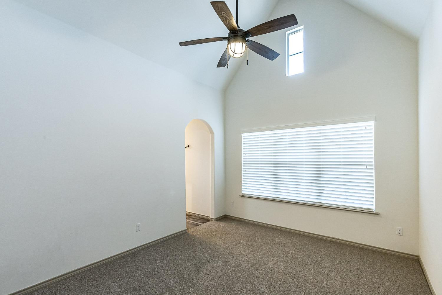 3633 133rd Street Lubbock, TX 79423 - Photo 31 of 46 an empty room with a window and a fan