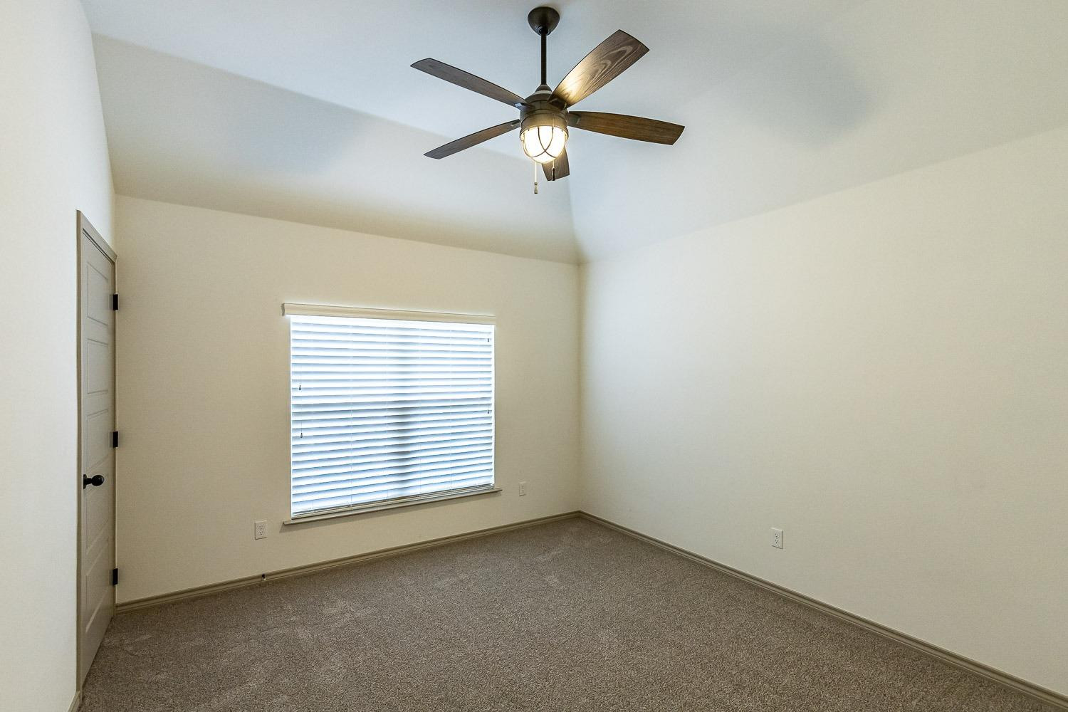 3633 133rd Street Lubbock, TX 79423 - Photo 35 of 46 an empty room with a window and a fan