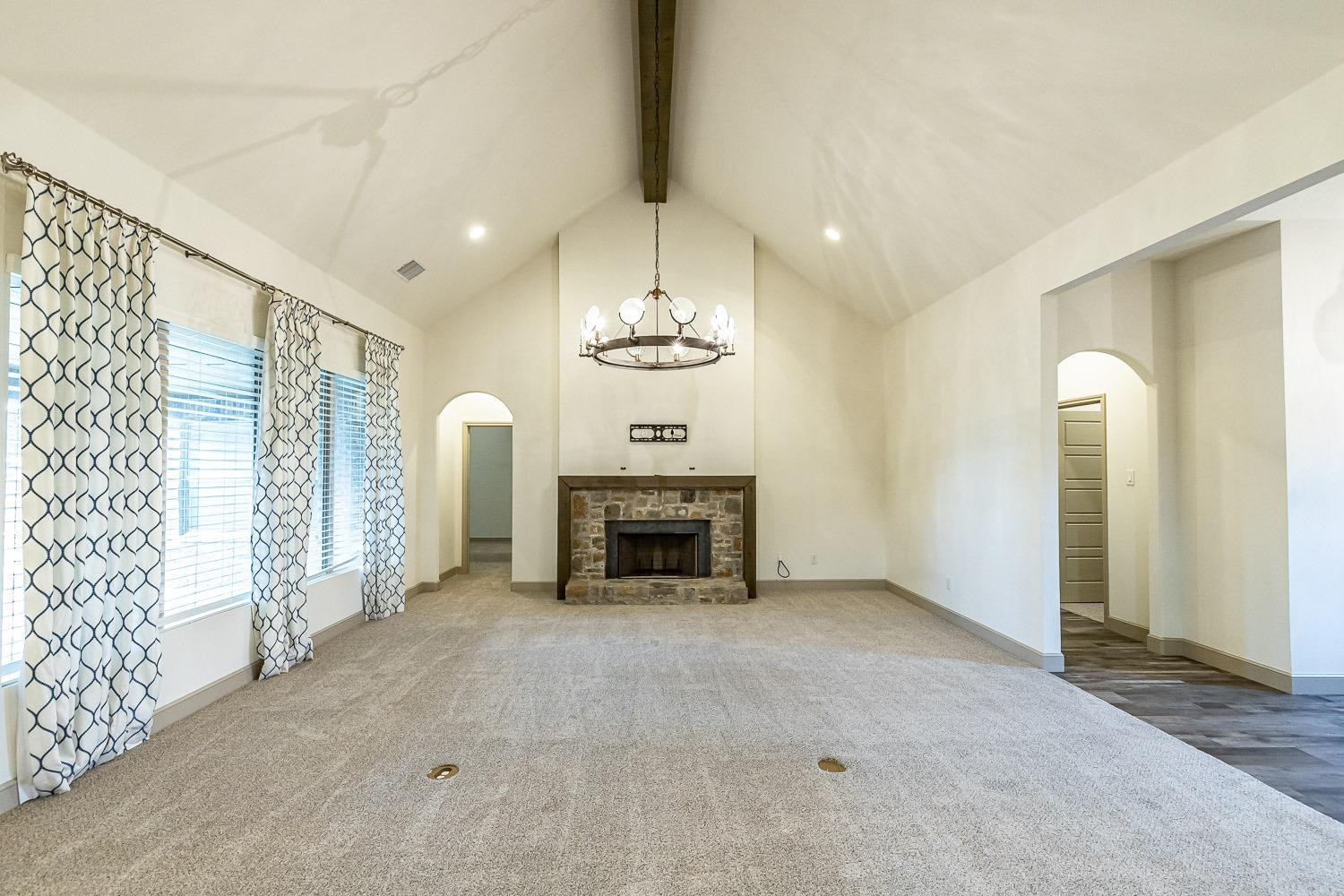 3633 133rd Street Lubbock, TX 79423 - Photo 5 of 46 a view of an empty room with fireplace and a window