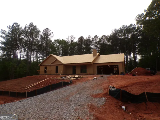 a front view of a house with yard and trees