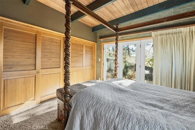 a bed sitting in a bedroom next to a window