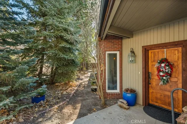 a view of a balcony with table and chairs and potted plants