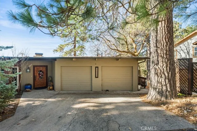 front view of a house with a tree