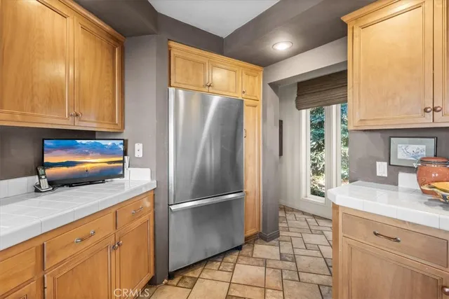 a kitchen with stainless steel appliances granite countertop a refrigerator a stove and a sink