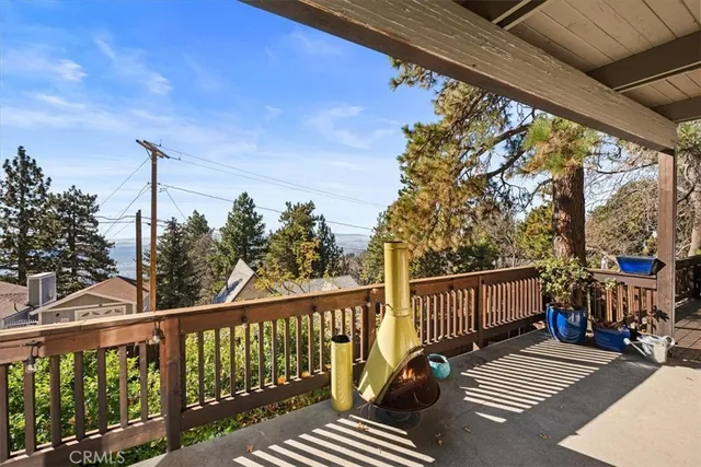 a view of balcony with wooden floor and fence
