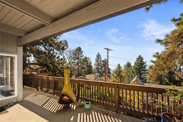 a view of a roof deck with wooden floor and fence
