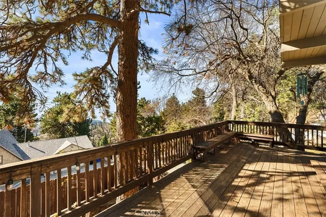 a view of balcony with wooden floor and fence